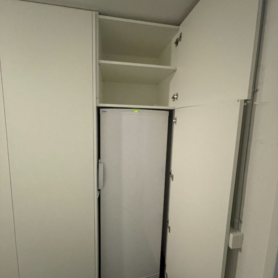 Weisser Einbauschrank mit Nische für einen hohen Kühlschrank